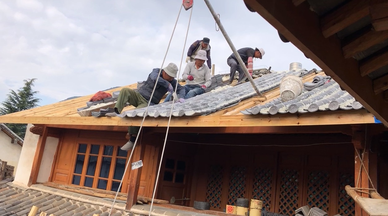 Photo of men at work on a traditional roof in China.