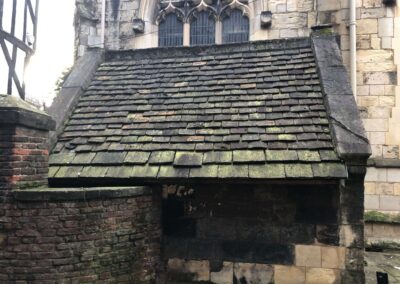 Historical English Church with stone roof tiles.