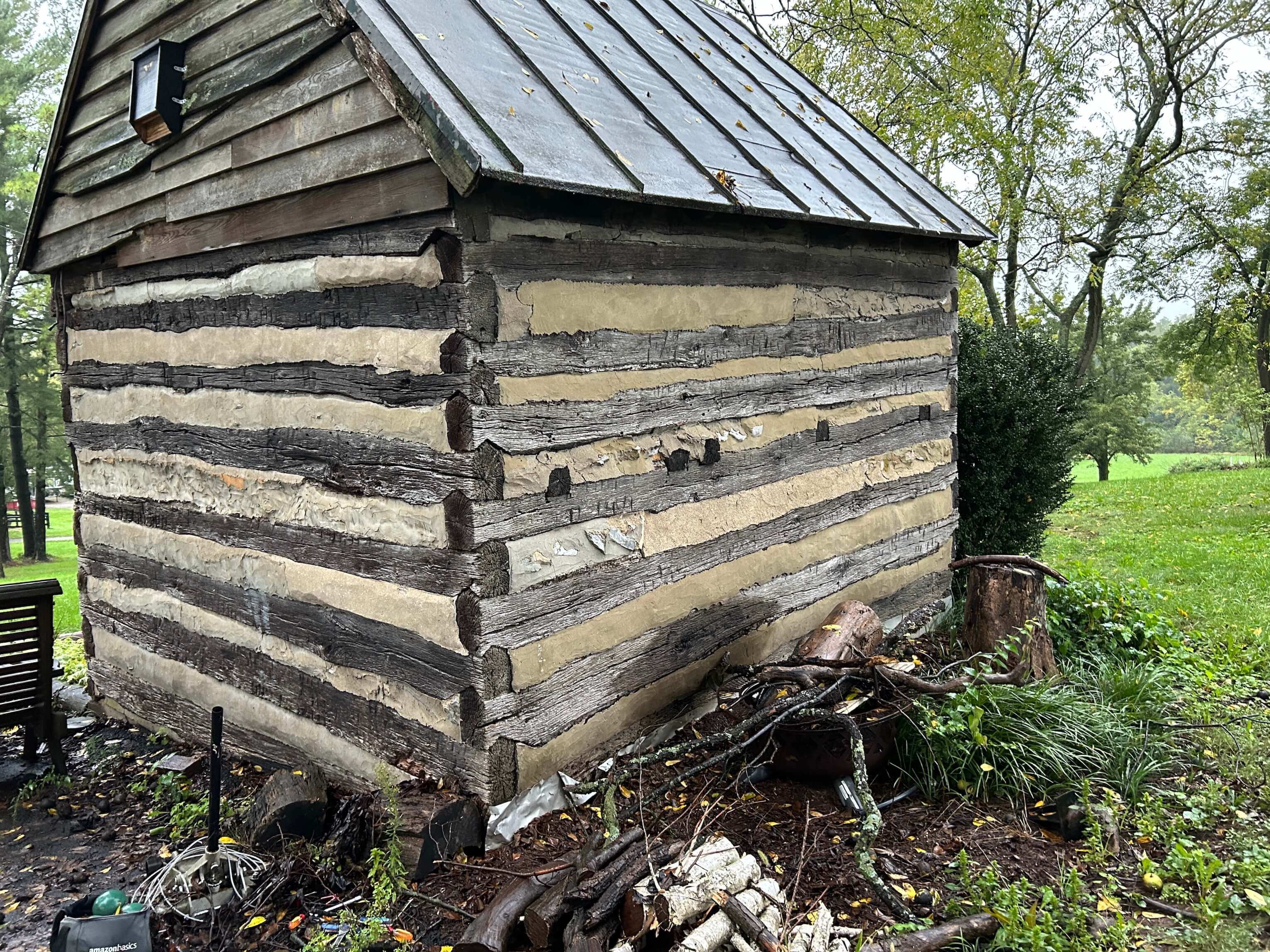 A historic 19th-century log cabin improperly daubed with Portland cement.